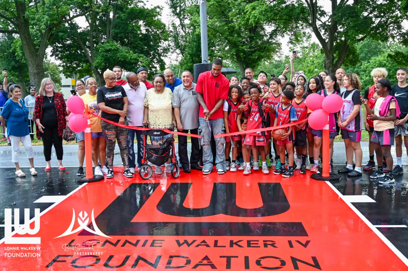 Community members at the Lonnie Walker IV Foundation court dedication ribbon cutting