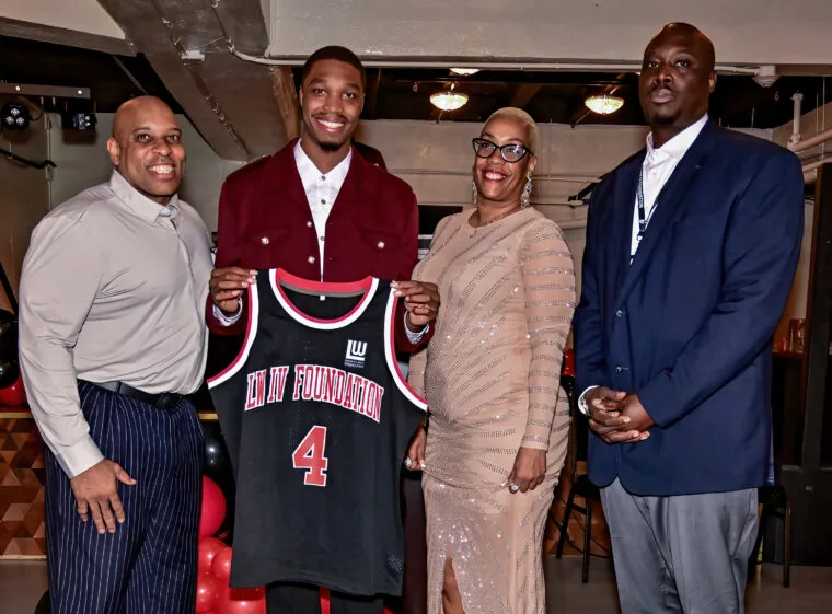 Lonnie Walker IV presenting a Foundation jersey to gala honorees