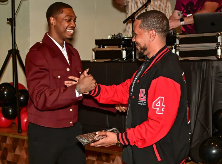 Lonnie Walker IV presenting an award at the Community Appreciation Gala