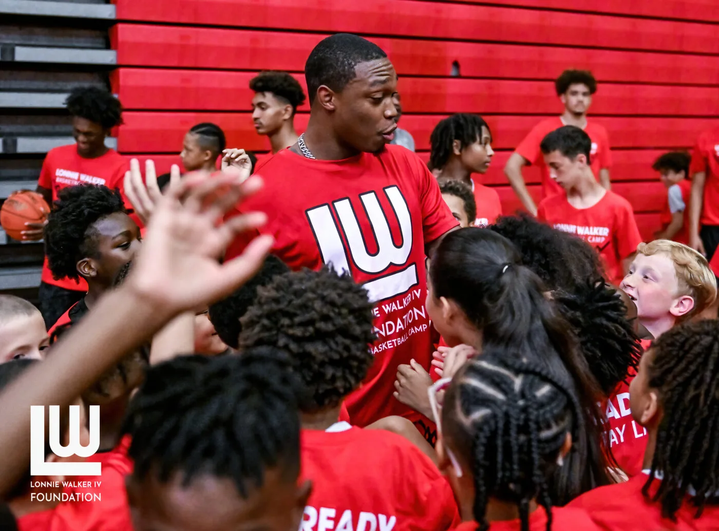 Lonnie Walker IV speaking with campers at the free youth basketball camp