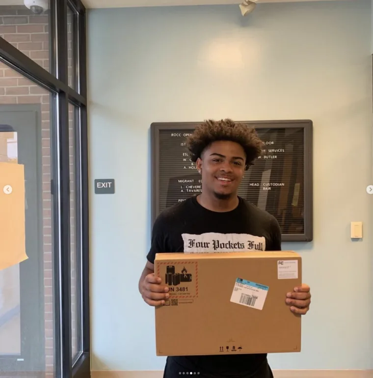 A graduating senior receiving a laptop award