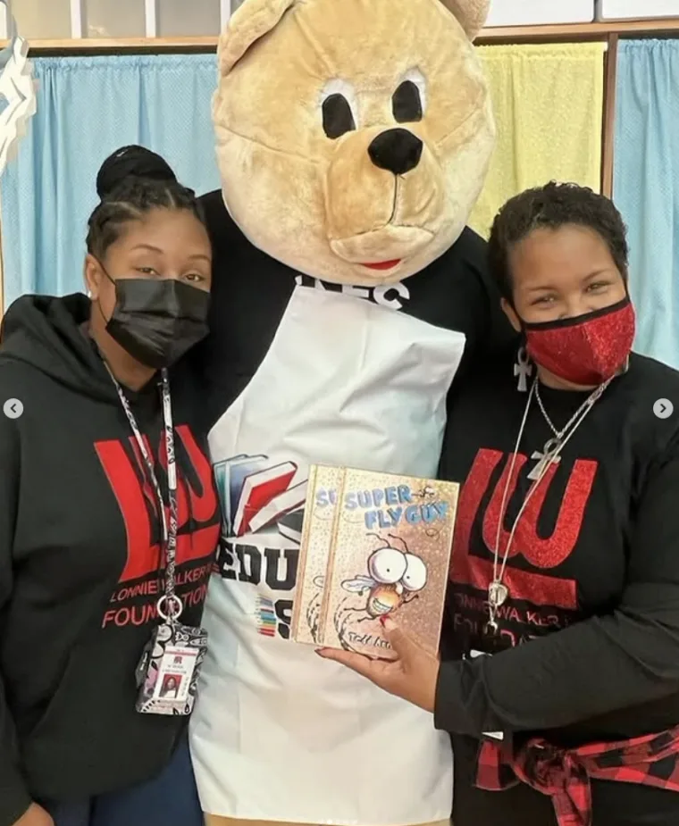Volunteers and a mascot at a school reading event