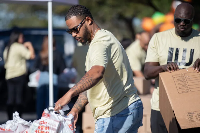 Volunteers packing groceries at the Turkeys for Teachers giveaway