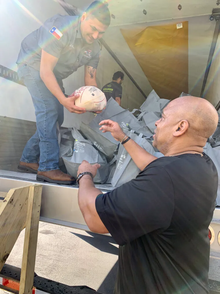 A volunteer handing out a turkey at the giveaway