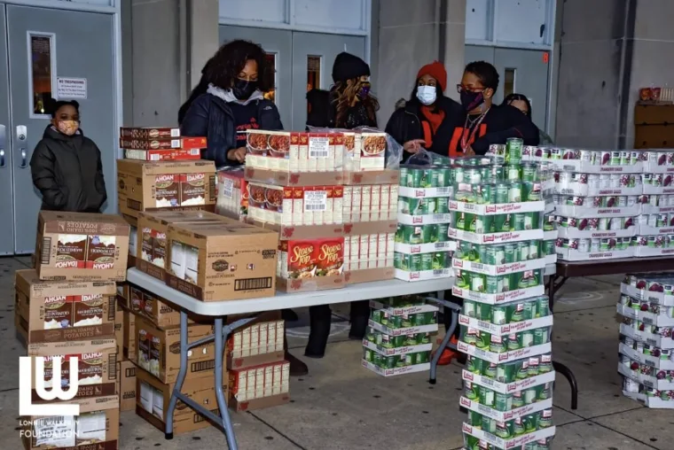 Cases of food stacked for the Thanksgiving meal giveaway