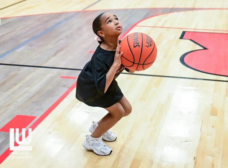 A camper lining up a shot during the basketball camp