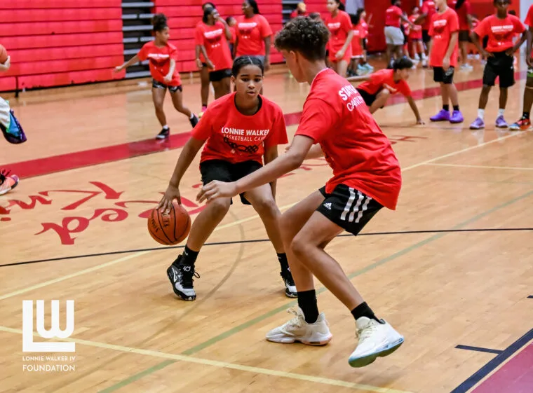 Two campers playing one-on-one during a camp drill